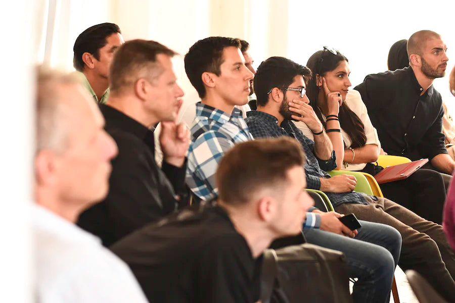 Men and women listening closely to seminar speaker on emotional grounding techniques and a course called why men just don't get it. Course on Romance, Love, mentally stimulating and emotionally fulfilling and meaningful communication!