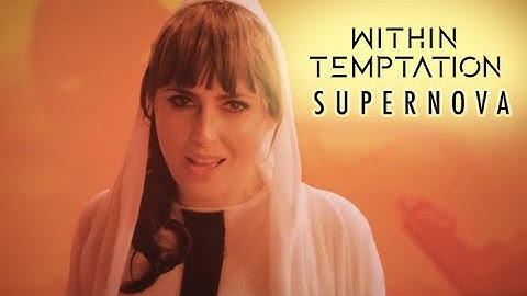 Spiritual Awakening through Emotional Healing | Within Temptation song - SuperNova | Singer Sharon den Adel is wearing a white shawl singing into the microphone with an orangish background