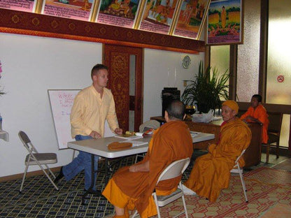 Mike Kollin teaching a group of Buddhist monks.