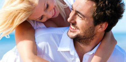 Broken to Bulletproof women's coaching - happy couple with blonde woman playfully embracing man at beach ocean setting